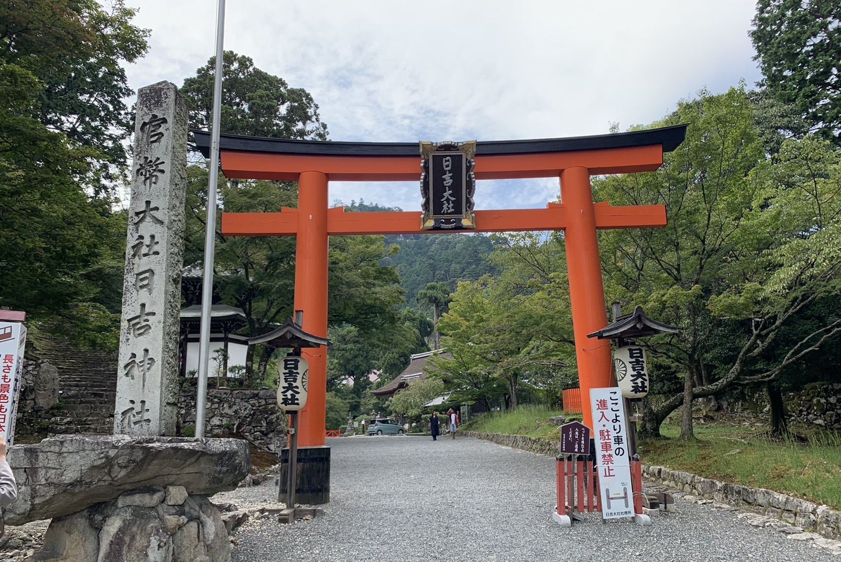 「日吉大社」の扁額がかかった朱色の大鳥居と、その奥へ続く参道