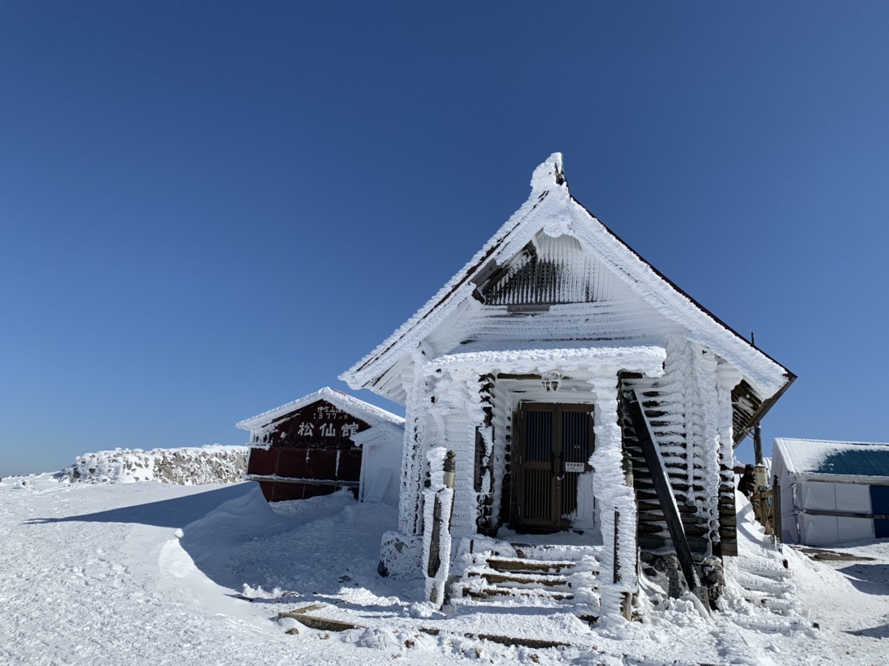 雪と氷にびっしり覆われた山頂の建物